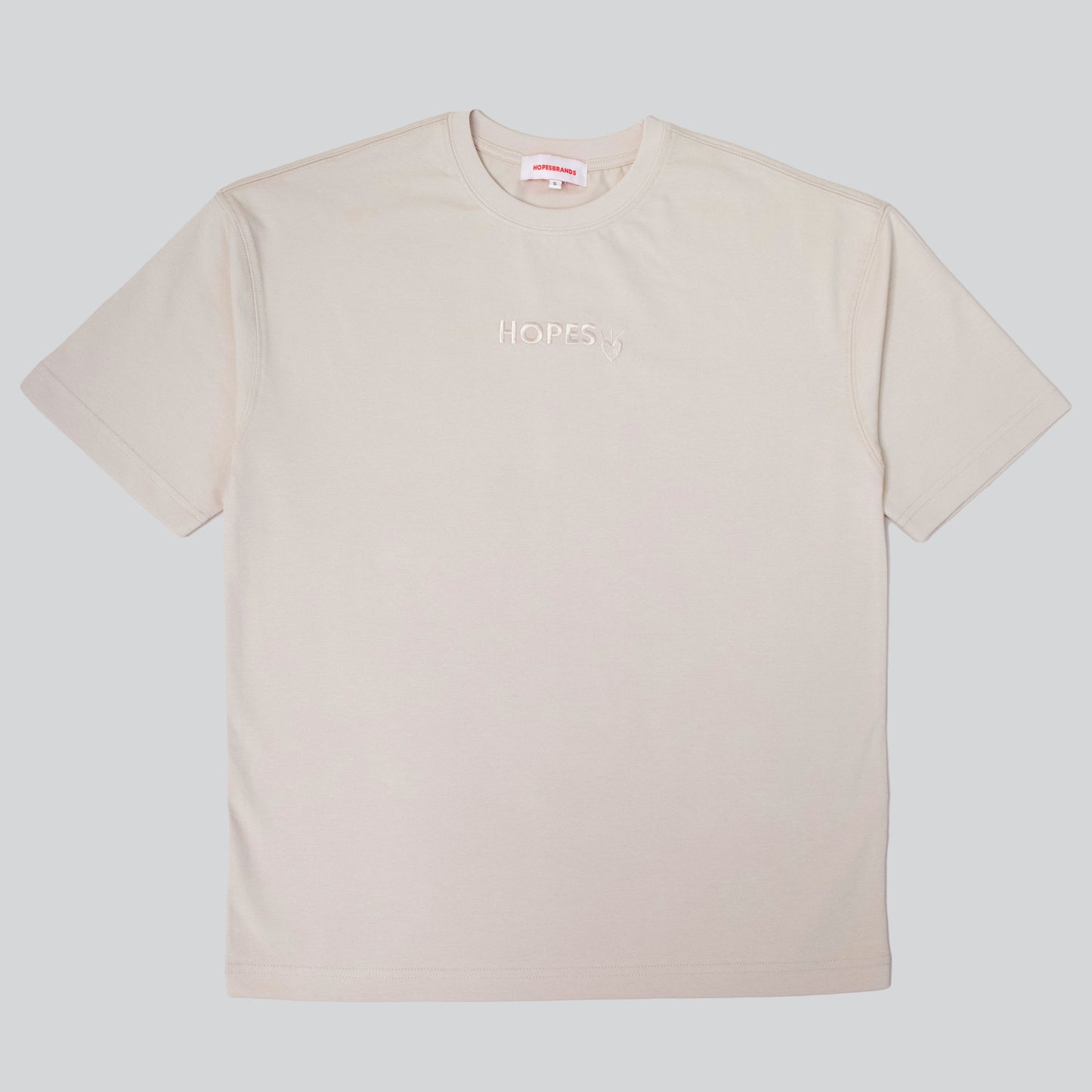 Product shot of Hopesbrands men's beige tonal short sleeve T-shirt with embroidered Hopes logo on the chest, offering comfort and timeless appeal.