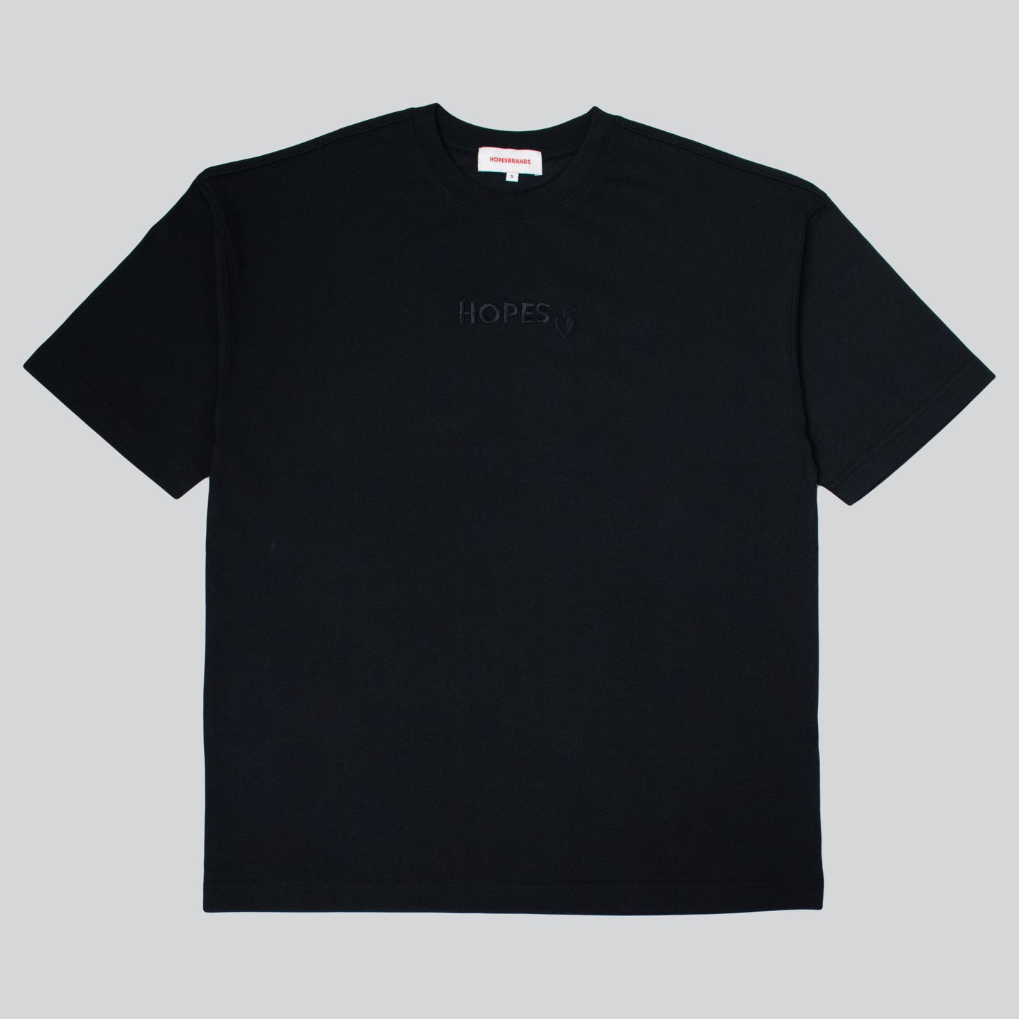 Product shot of Hopesbrands men's black tonal short sleeve T-shirt with tone-on-tone embroidered Hopes logo on the chest. The sleek, versatile design highlights comfort and timeless appeal, making it a staple for casual outfits.