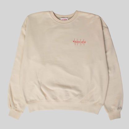 Product shot of the Hopesbrands Big Heart crewneck sweatshirt in tan, featuring red lifeline stitches on the left chest and crafted from a comfortable cotton blend.