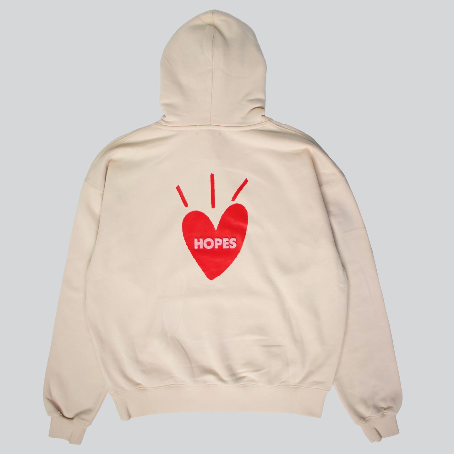 Big Heart hooded sweatshirt in tan with printed Big Heart logo and red-toned toothbrush embroidery on the back.