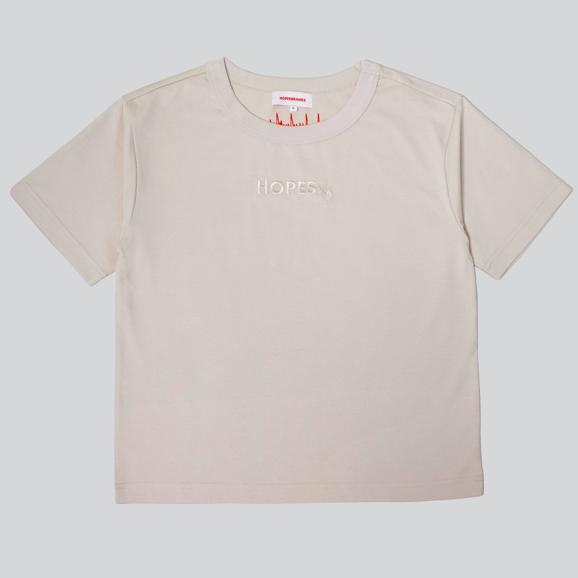 Hopesbrands women's beige tonal short sleeve T-shirt with tone-on-tone embroidered Hopes logo, offering a sleek and versatile design.